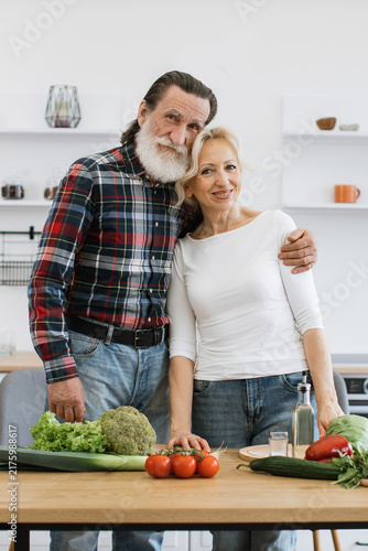 Canvastavla An elderly couple smiles warmly while preparing healthy food in a bright, modern
