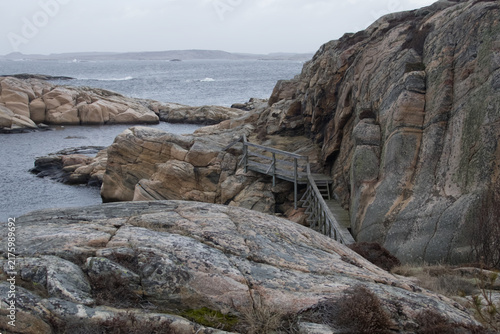 Wooden Footbridge and Stairs on Rocky Coastal Cliffs in Sweden