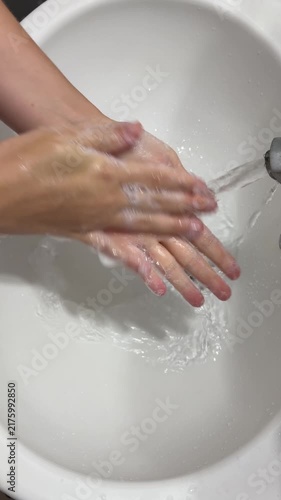 Close-up of a person washing their hands with soap and water. Everyday hygiene routine emphasizing cleanliness, hand care and healthy habits.