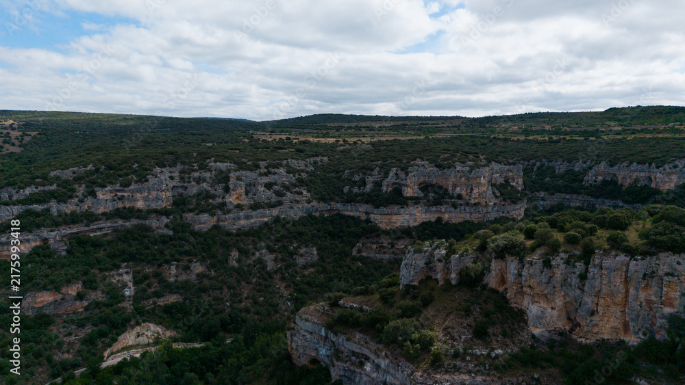 Obraz premium serene canyon landscape with rock formations and vegetation in rural setting viewed from aerial perspective, nature photography, Risco los camellos, Cascada de Orbaneja del Castillo