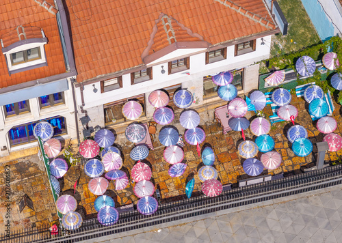 Aerial view of the Old Bazaar with colorful umbrellas shading an outdoor terrace on stone pavement in Skopje, Greater Skopje, North Macedonia.