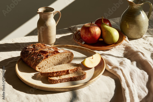 Rustic sourdough bread with apple, pear and ceramic pitcher
