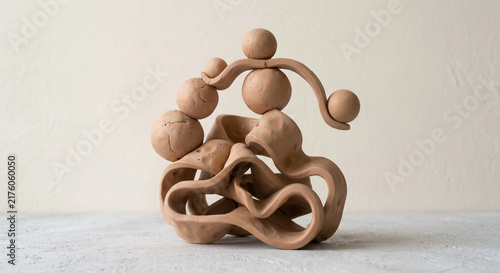 Abstract Terracotta Clay Sculpture with Spherical and Organic Shapes on Textured Surface