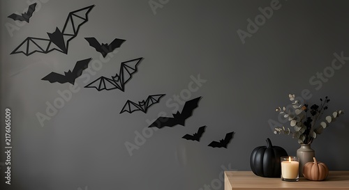 Scandinavian Halloween wall decor with flying geometric bat silhouettes, pumpkin, and candle display