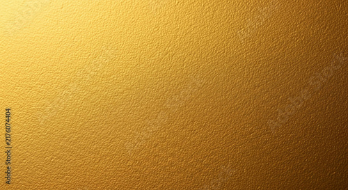 A magnificent golden metallic sheet displaying a rich texture and warm shimmering luminance ideal for luxury design projects