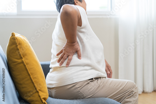 Older woman feeling back pain at home
