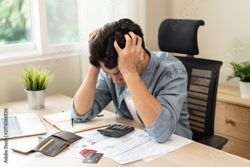 Cuadro en lienzo Stressed bankrupt financial crisis concept, Young adult in nervous after calculated loan expense and can not pay to bank