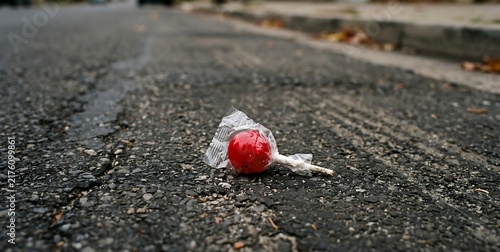 Red Lollipop Lying on Road
