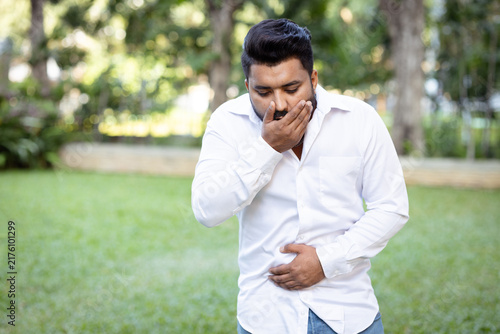 Cuadro en lienzo young adult south asian man in his 20s feeling nauseous and about to vomit in ou