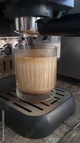 Freshly brewed coffee with creamy foam in a glass cup. morning energy, barista craft, coffee shop lifestyle.