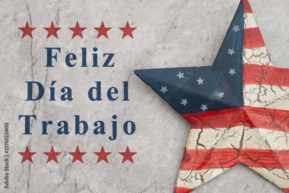 Fototapeta premium Feliz Día del Trabajo text with retro USA red and blue star on stone for Happy Labor Day