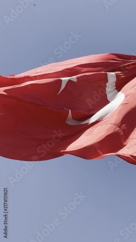 Turkish flag waving proudly in the wind against a clear blue sky, capturing the majestic details of the crescent and star in high-quality 4K footage, perfect for national holidays, patriotic themes, a