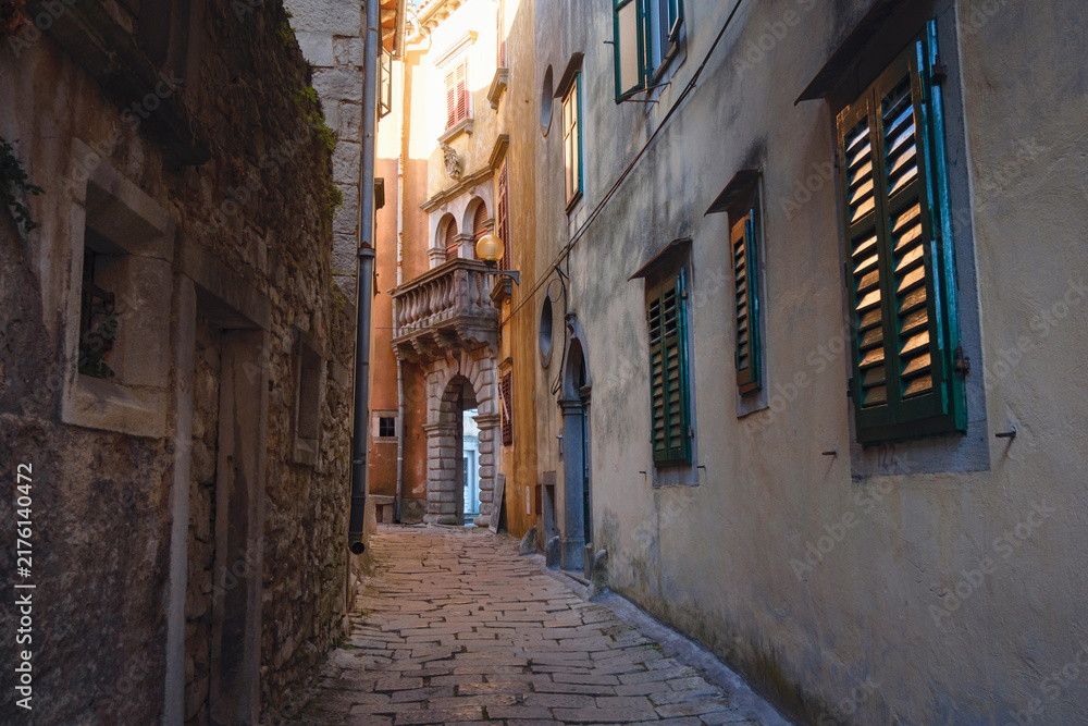 Fototapeta premium Scenic views of old town Labin in Istria, Croatia. Historic stone houses, tiled roofs, church facade, cozy narrow streets,
