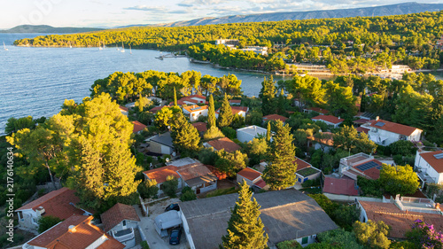 High angle drone shot displays stunning coastal landscape of Hvar Island. Panorama includes historic Stari Grad port