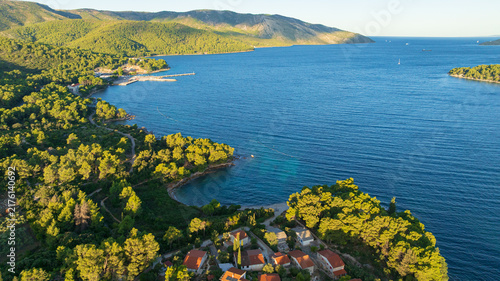 High angle drone shot displays stunning coastal landscape of Hvar Island. Panorama includes historic Stari Grad port