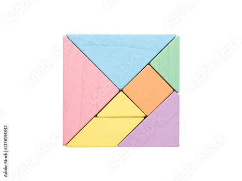 Colorful tangram puzzle wooden geometric shapes assembled into square top view isolated on black background for business strategy logic problem solving creative solution education concept.