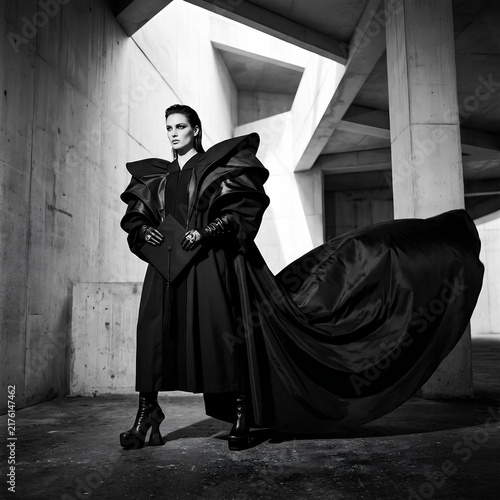 Avant garde Fashion Model Poses in Dramatic Black Outfit with Flowing Cape