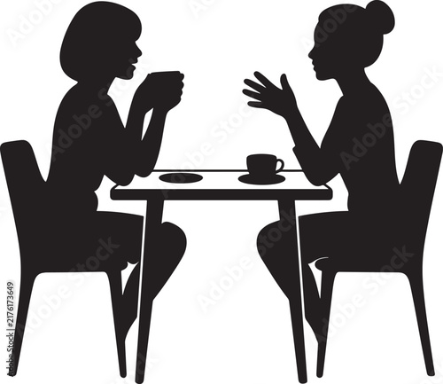 Silhouette of two women talking and drinking coffee at a cafe table