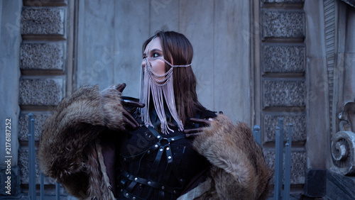 Obraz na płótnie Woman with hidden face in chain mask and leather harness, anonymity and privacy concept