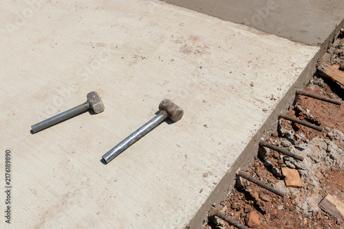 Canvastavla Construction sledges on concrete paving with exposed steel rebar dowels