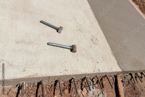 Konstfotografi Construction sledges on concrete paving with exposed steel rebar dowels