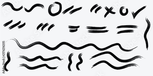 Abstract black brush strokes on white background with varied shapes and textures for graphic design elements