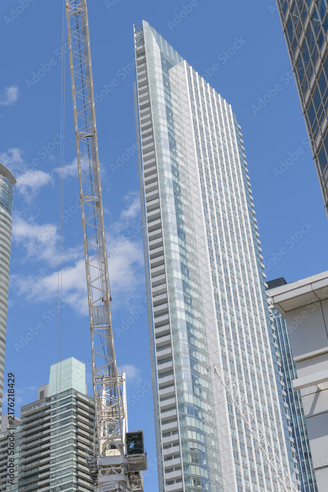 Obraz premium southwest elevation of 10 York Street, a condominium, with construction crane at future site of Q Tower, developed by Lifetime Developments and DiamondCorp, Toronto