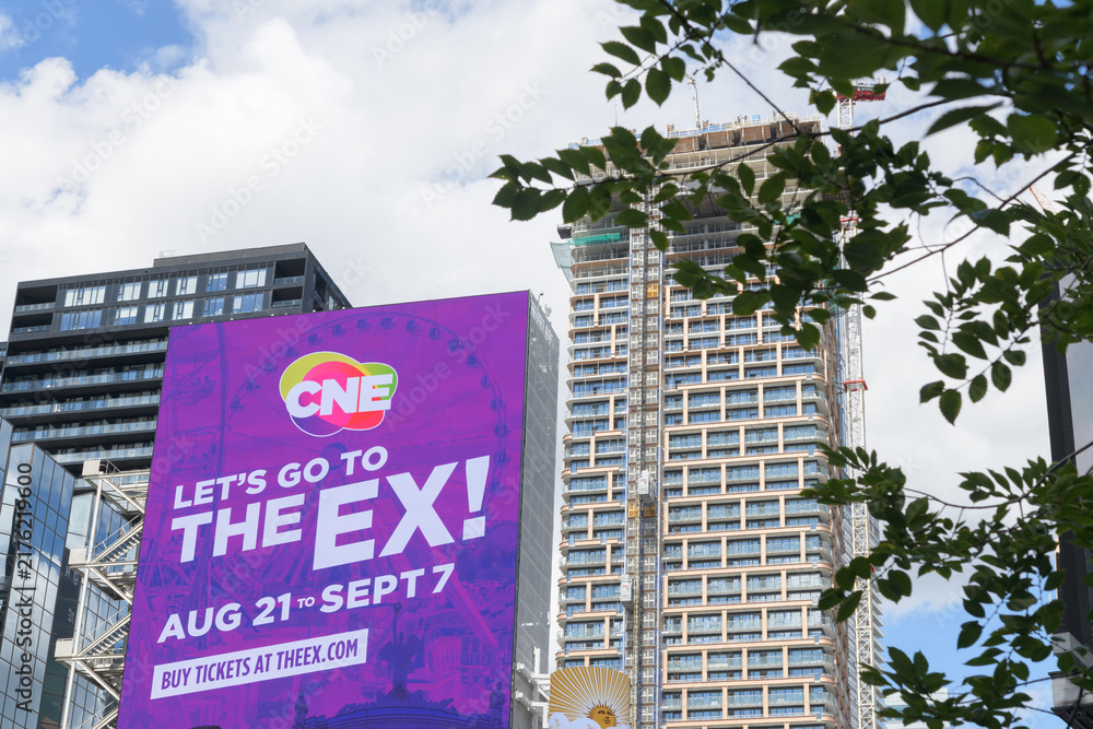 Obraz premium large commercial digital billboard featuring advertisement for the Canadian National Exhibition, CNE / The Ex at Yonge and Dundas W, Toronto