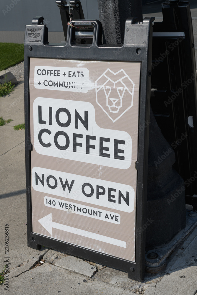 Obraz premium sidewalk a-frame sign with poster for Lion Coffee, a coffee shop, located at 140 Westmount Av, Toronto