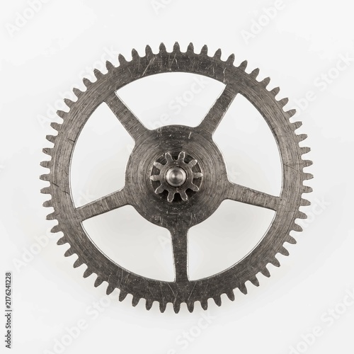 Metal gear wheel showing intricate mechanical details and brushed steel texture isolated against a clean bright white studio background surface