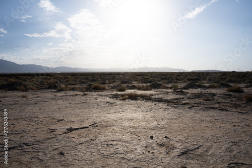 Canvas Print Drought cracked earth and distant mountains desert landscape