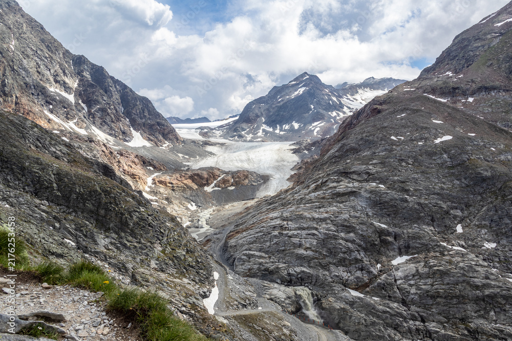 Obraz premium Glacier and rocky mountain landscape with waterfall, Austria, Tyrol, Mittelberg (Pitztal), 29 June 2026