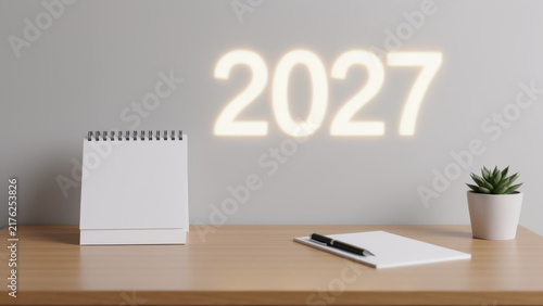 Minimal white 2027 display beside a clean desk calendar and small plant creating a modern new year planning scene for business goals schedules annual strategy and fresh beginnings