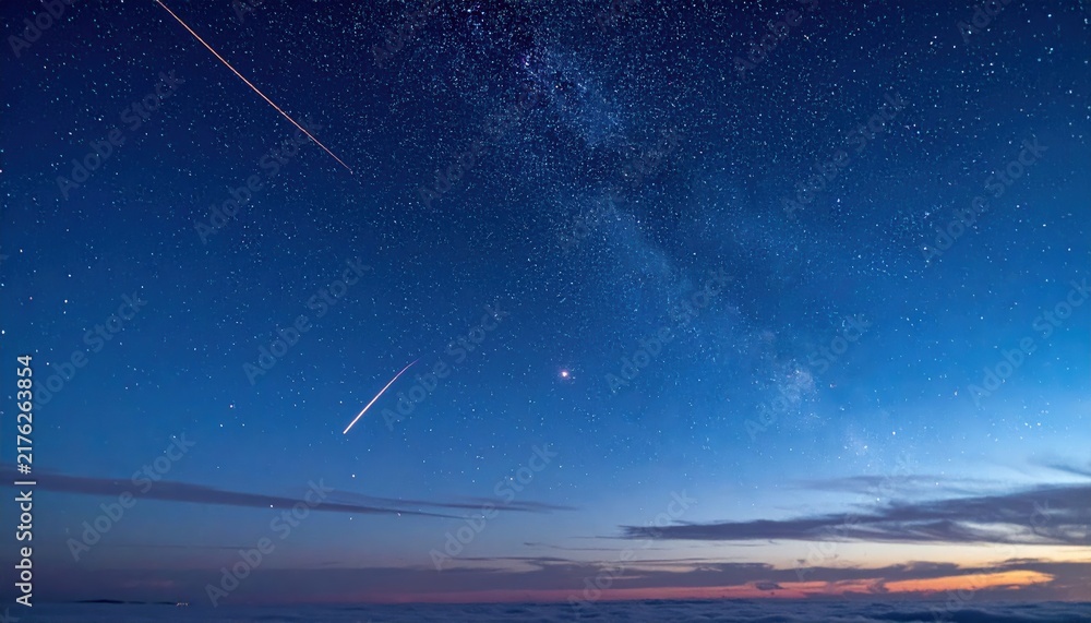 Fototapeta premium Stunning starry night sky with shooting stars and milky way galaxy at dawn.