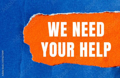 Fotografie We need your help message written on ripped torn paper background