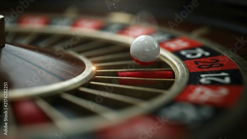 Close-up of a roulette wheel with a white ball in the betting area at a casino