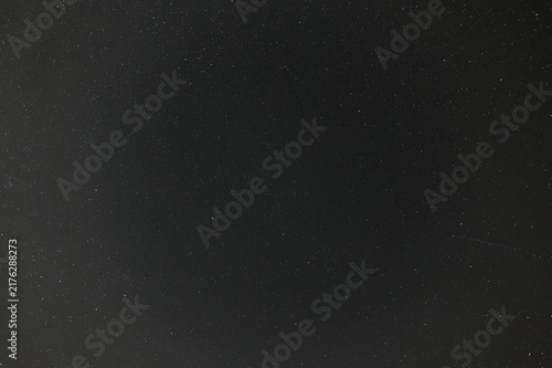 Starry Night Sky Background with Faint Meteor Trails and Deep Space Stars
