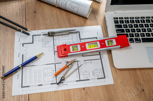 Top View Architectural Blueprint Floor Plan with Laptop Spirit Level and Tools Flat Lay Desk