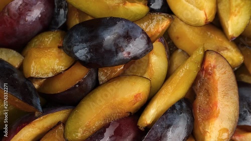 Sliced plums in bowl, rotation