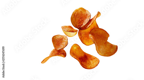 Foto Crispy golden paprika seasoned potato chips falling in a pile