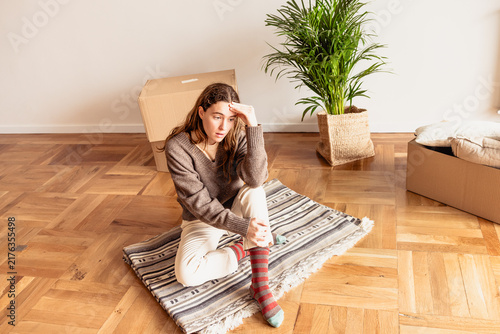 Overwhelmed young woman feeling stressed during relocation
