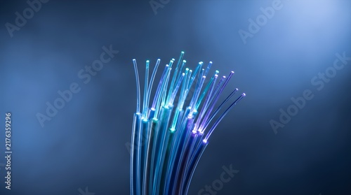 Plakat Vibrant glowing fiber optic cable bundle transmitting digital data over dark blue background.