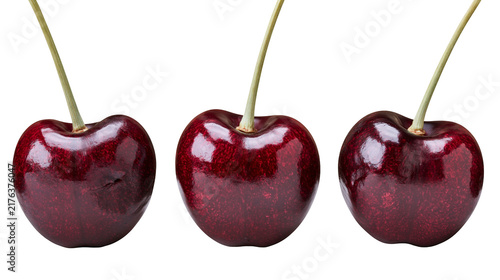 Fotografie Three ripe dark red cherries with green stems