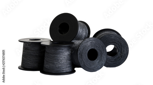 Obraz na plátně Group of black plastic spools wound with dark grey synthetic sewing thread