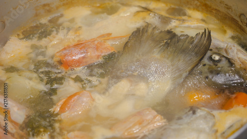Картината върху платно African fish and seafood stew boiling in a pot, preparing traditional cuisine wi
