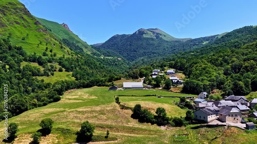 Drone flying over Col d'Aubisque valley and traditional village in French Pyrenees