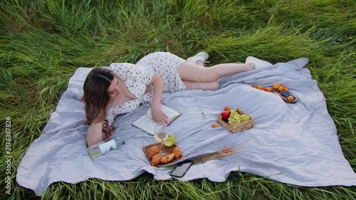 Enjoying a Relaxing Summer Picnic with a Book and Fresh Fruits