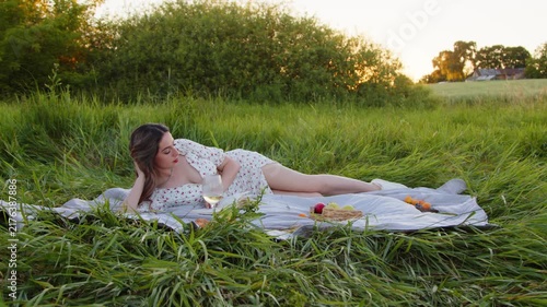 Having a Serene Outdoor Picnic Enjoying the Beautiful Sunset Glow