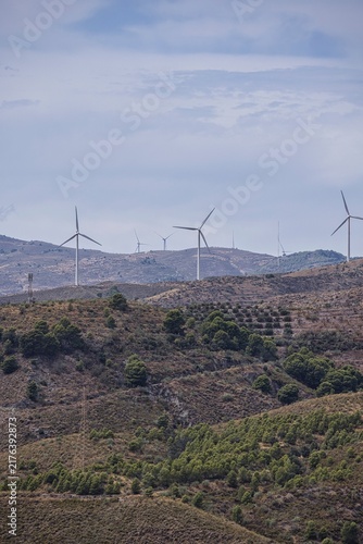 Wind farm turbines generating clean energy on hills