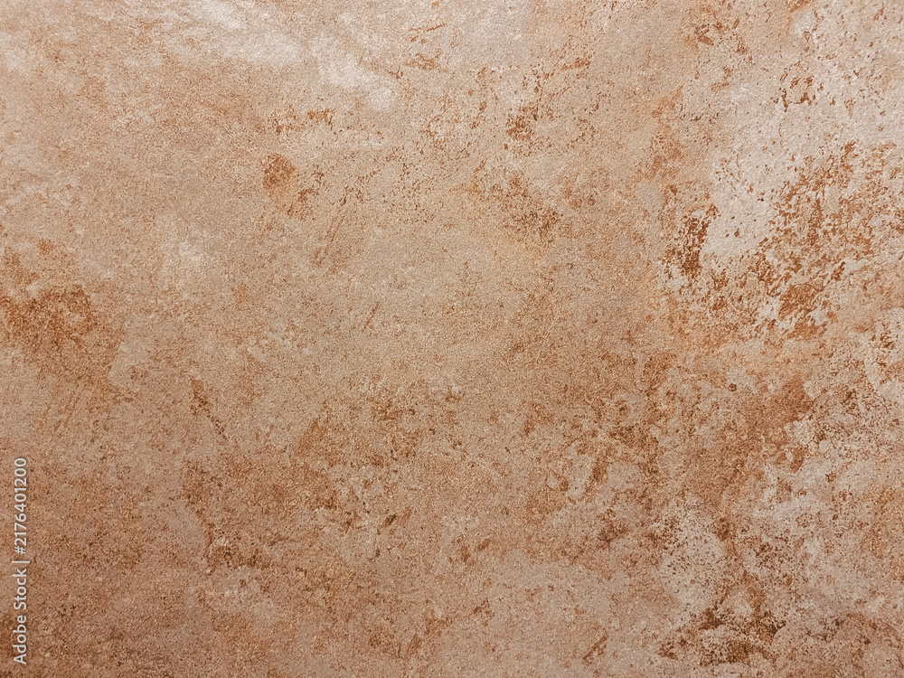 Fototapeta premium Close up of a textured brown stone surface with natural patterns and earthy tones, suitable for backgrounds or design elements.